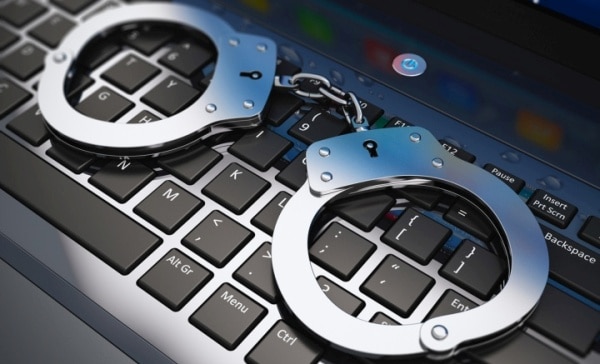 Handcuffs on laptop keyboard